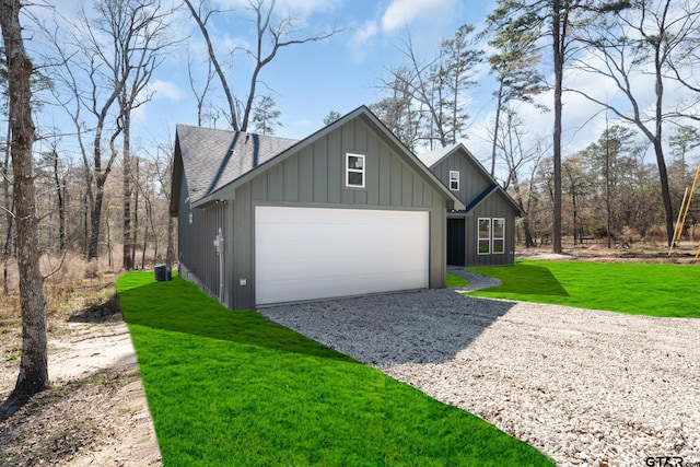 exterior space with a garage and a lawn