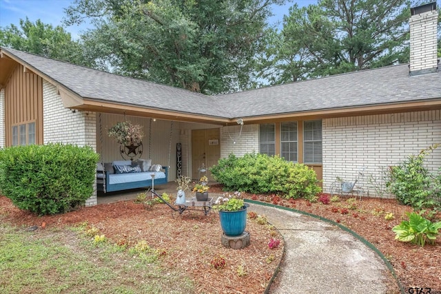 view of exterior entry with outdoor lounge area