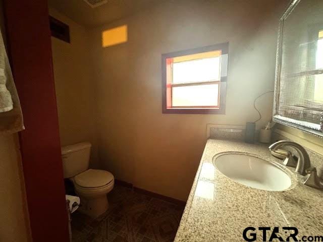 bathroom with vanity and toilet