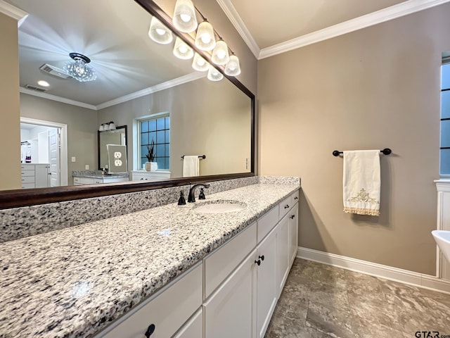 bathroom with crown molding and vanity