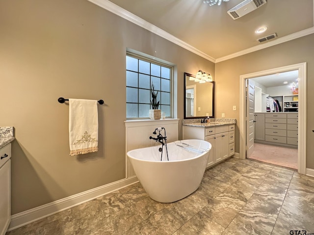 bathroom with vanity, crown molding, and a tub to relax in