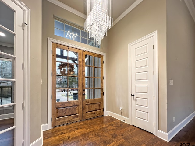 entryway featuring dark hardwood / wood-style flooring, ornamental molding, a chandelier, and french doors