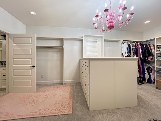 spacious closet with an inviting chandelier and carpet