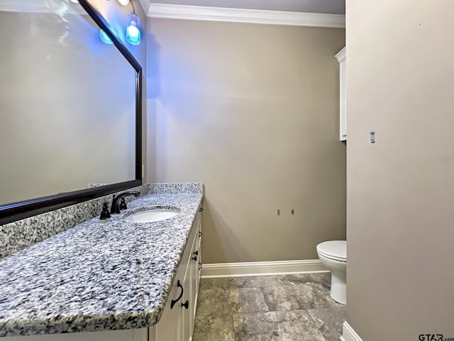 bathroom with crown molding, vanity, and toilet