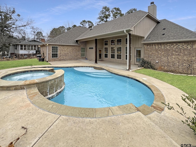 view of swimming pool featuring an in ground hot tub and a patio