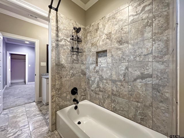 bathroom featuring tiled shower / bath combo and crown molding