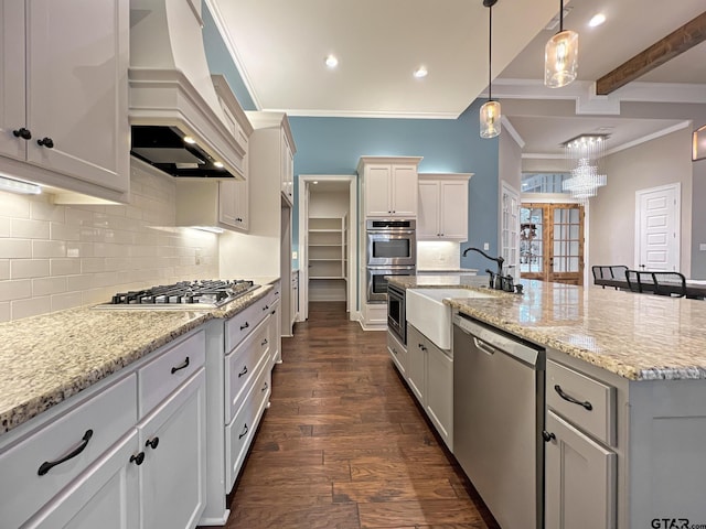 kitchen featuring sink, appliances with stainless steel finishes, a kitchen island with sink, premium range hood, and beam ceiling