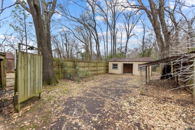 view of yard featuring an outdoor structure and fence