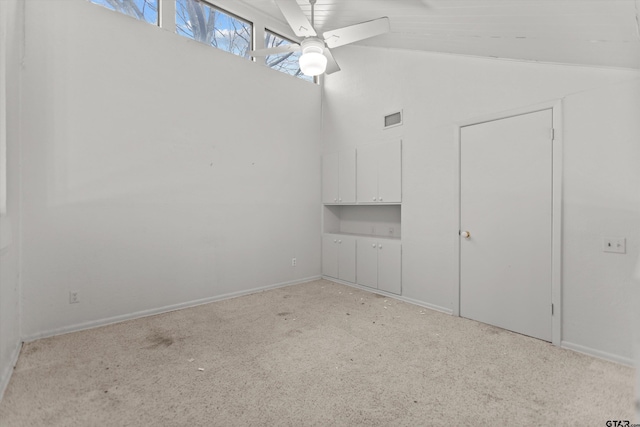 unfurnished bedroom with high vaulted ceiling, a ceiling fan, visible vents, and light colored carpet