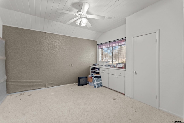 carpeted spare room featuring vaulted ceiling, ceiling fan, and wooden ceiling