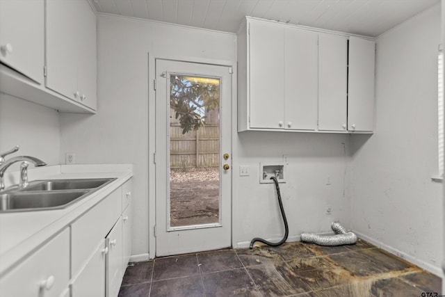 laundry room with cabinet space, baseboards, ornamental molding, hookup for a washing machine, and a sink