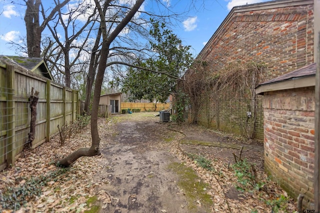 view of yard with a fenced backyard and an outdoor structure