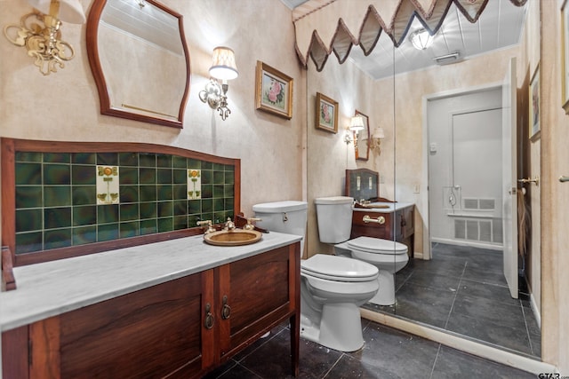 bathroom with visible vents, vanity, toilet, and tile patterned floors