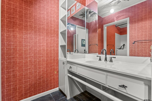 bathroom featuring tile patterned flooring, vanity, and baseboards