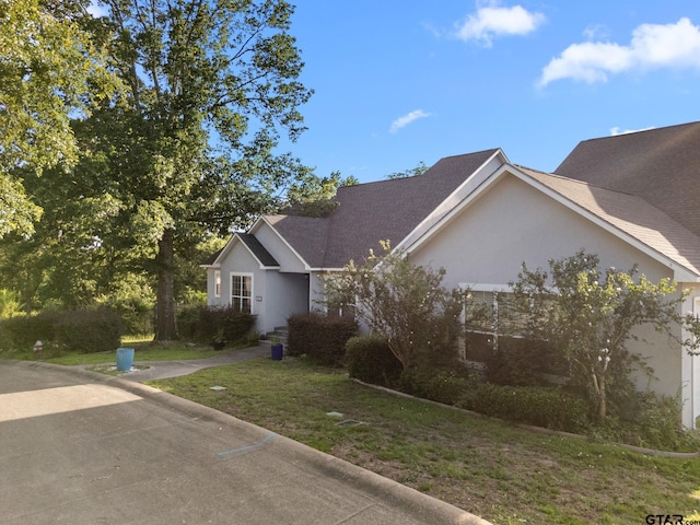 7031 Ridge Place Cir, Tyler, TX 75703 - view of front of property with stucco siding and a front lawn