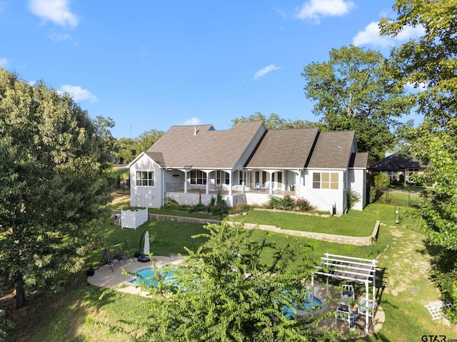 7031 Ridge Place Cir, Tyler, TX 75703 - rear view of house featuring a lawn, a patio, covered porch, and roof with shingles