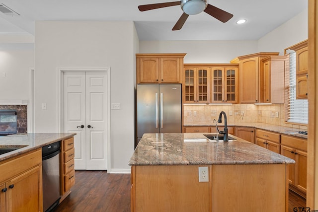 7031 Ridge Place Cir, Tyler, TX 75703 - kitchen featuring stainless steel refrigerator, light stone countertops, backsplash, glass insert cabinets, and recessed lighting