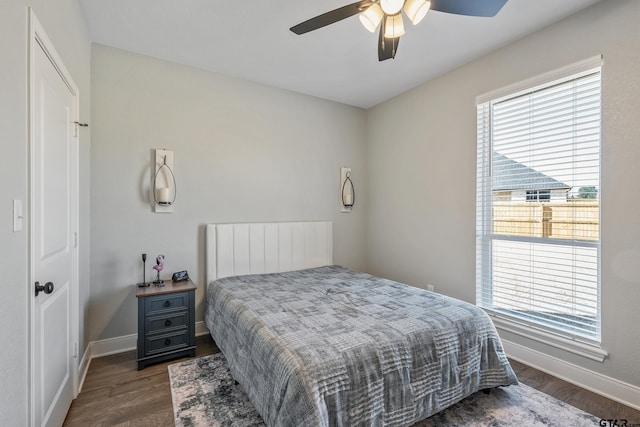 bedroom with ceiling fan, radiator, and dark hardwood / wood-style flooring