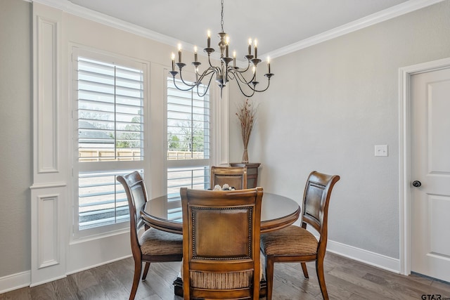 dining room featuring an inviting chandelier, dark hardwood / wood-style flooring, and crown molding