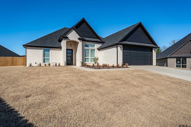 view of front of property featuring a front yard and a garage