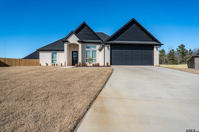 view of front of home with a front yard and a garage