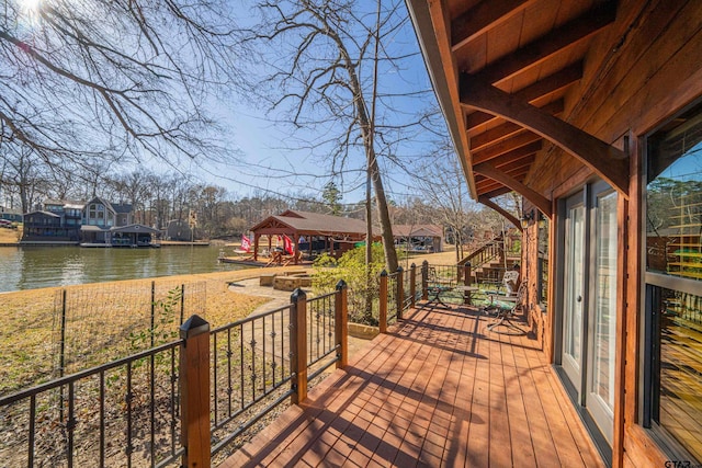 wooden terrace featuring a water view