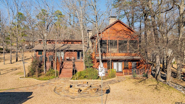 chalet / cabin with stairs and a chimney