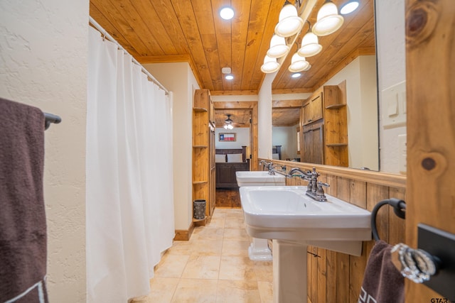 full bath featuring a shower with shower curtain, wooden ceiling, tile patterned flooring, a sink, and recessed lighting