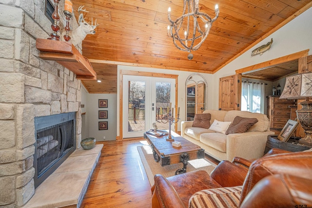 living room featuring lofted ceiling, a wealth of natural light, a fireplace, and wood ceiling