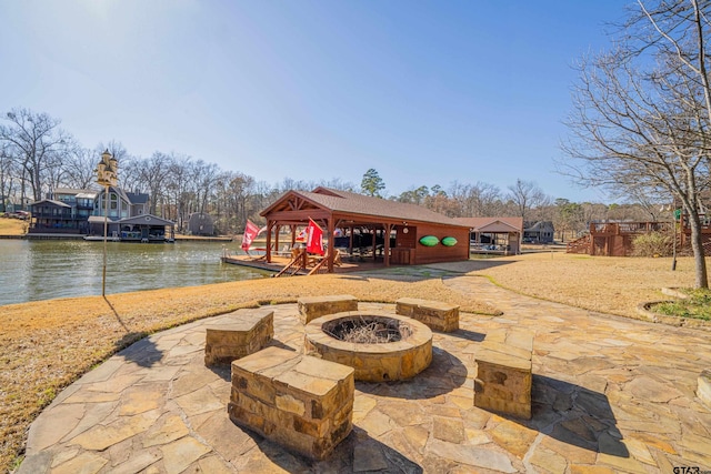 view of patio featuring a fire pit, a gazebo, and a water view