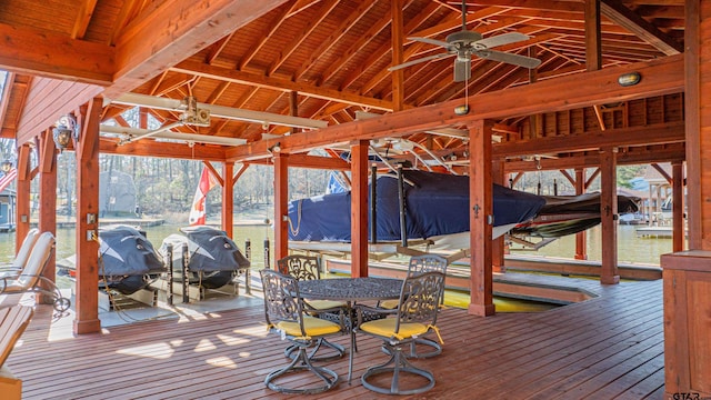 wooden terrace with a boat dock and boat lift