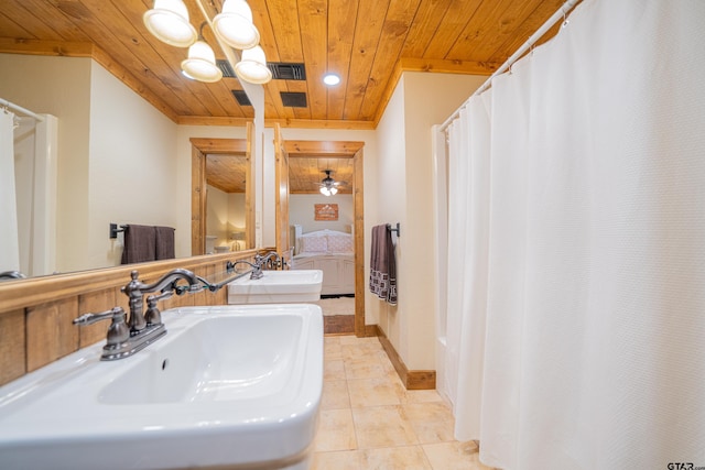 full bathroom with tile patterned flooring, wood ceiling, and a sink