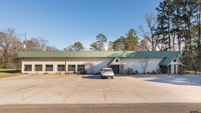 view of building exterior with uncovered parking