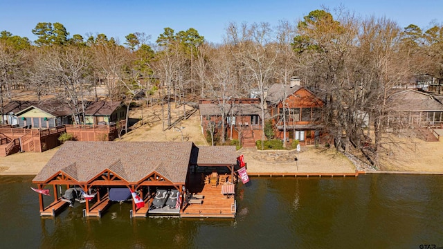 view of dock featuring a residential view, a water view, boat lift, and stairs