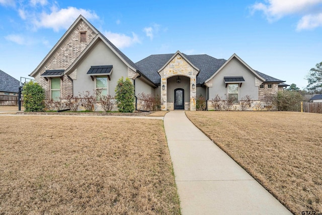 french country home featuring a front yard