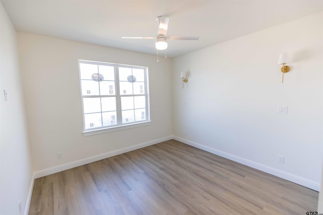 spare room featuring ceiling fan and light hardwood / wood-style flooring