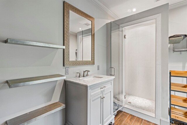 bathroom with vanity, an enclosed shower, and ornamental molding