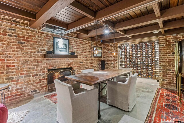 wine area featuring beam ceiling, a fireplace, and brick wall