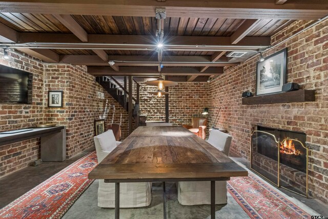 unfurnished dining area featuring a fireplace, beamed ceiling, and wood ceiling