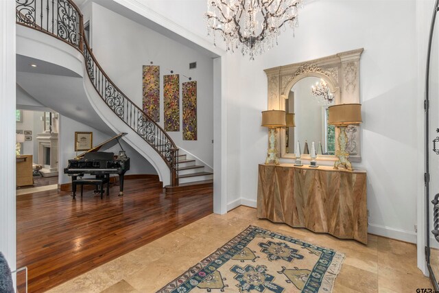 foyer featuring a high ceiling and an inviting chandelier