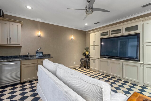 living room with ceiling fan and ornamental molding