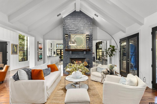 living room featuring a fireplace, beam ceiling, hardwood / wood-style flooring, and high vaulted ceiling