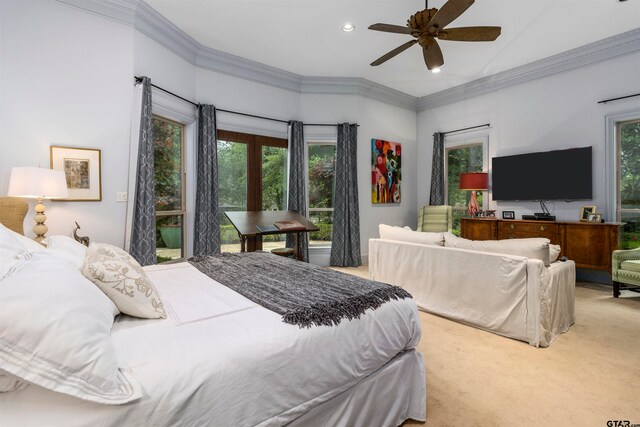 bedroom with ceiling fan, crown molding, and carpet