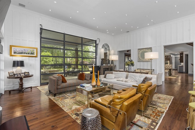 living room featuring crown molding and dark hardwood / wood-style flooring