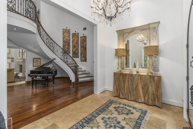 entryway featuring a high ceiling and an inviting chandelier