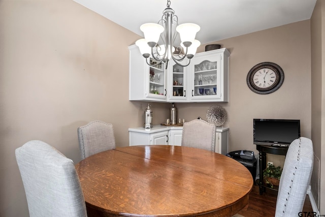 dining room featuring dark hardwood / wood-style flooring and a chandelier