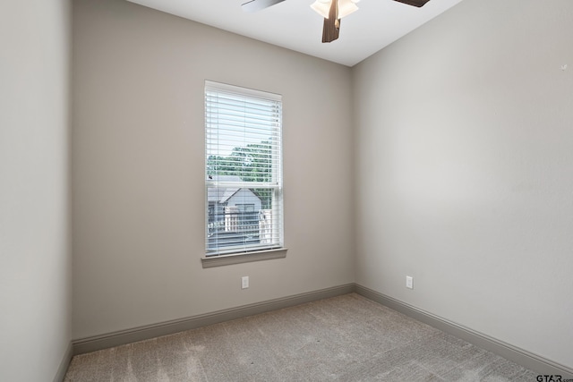 unfurnished room with carpet, baseboards, and ceiling fan