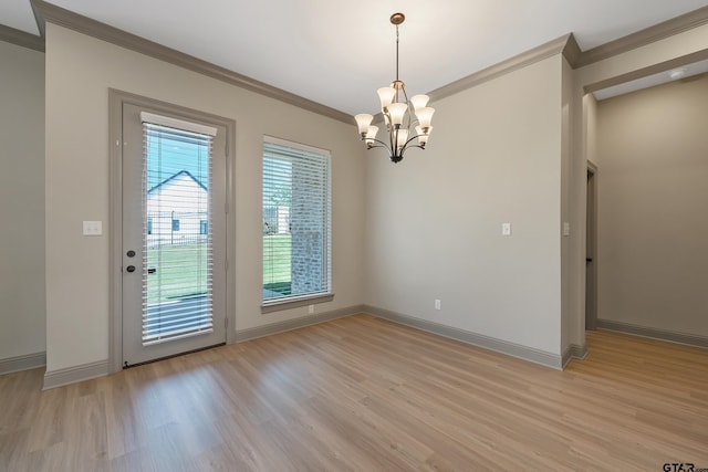 unfurnished dining area with a notable chandelier, baseboards, crown molding, and light wood-style floors
