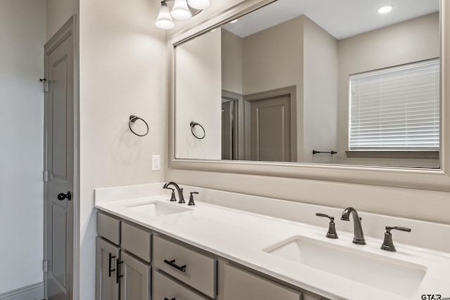 full bath with a sink and double vanity