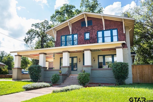 view of front of house with a porch and a front yard